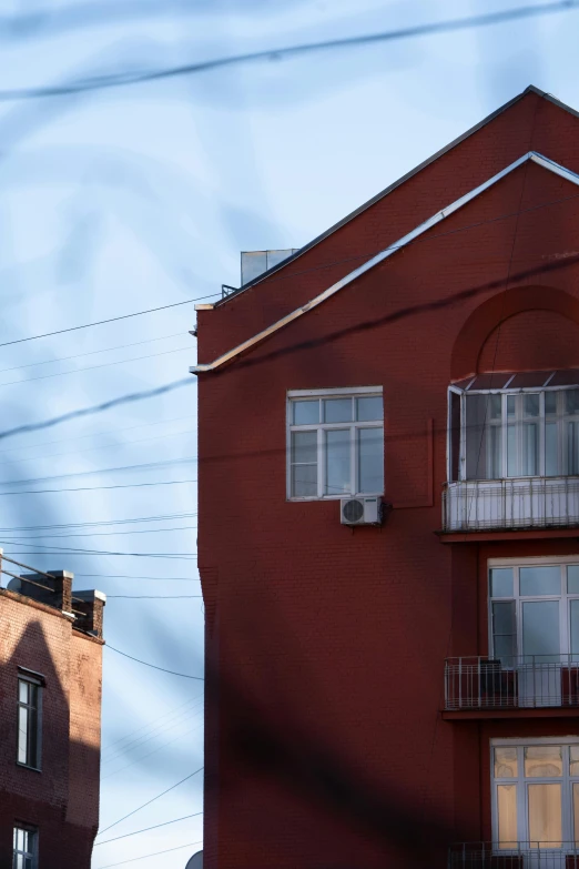 two buildings with balconies and one with a clock