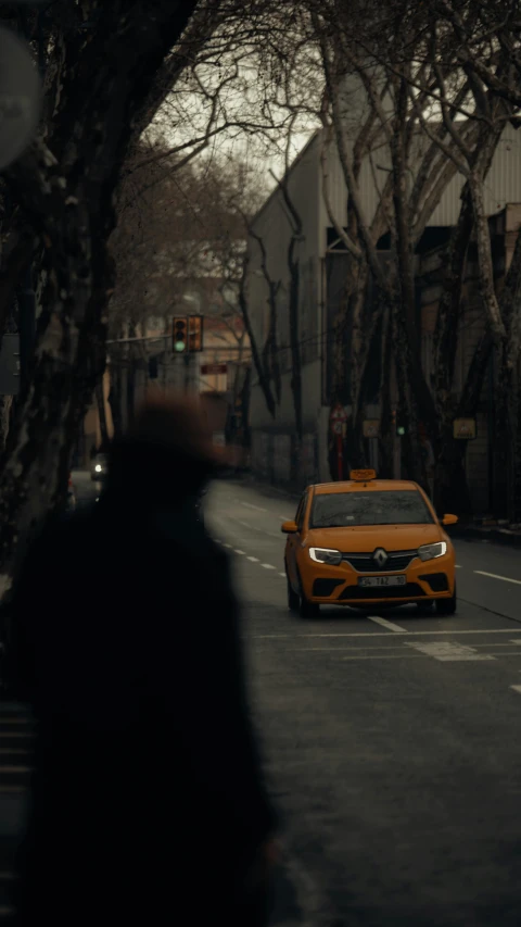 car driving down a dark street past a building