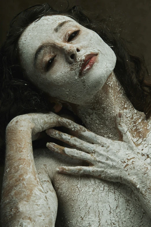 a woman covered in white powder on her face