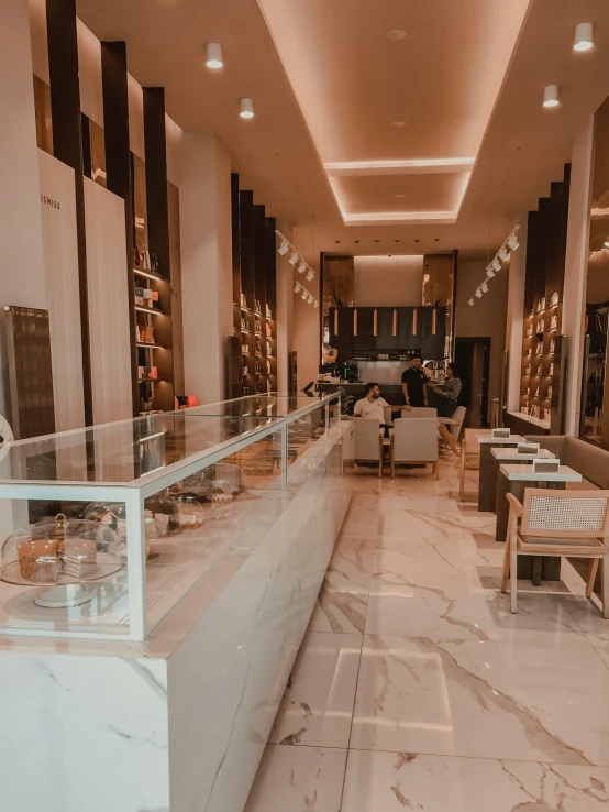 a large marble counter and some chairs in a lobby