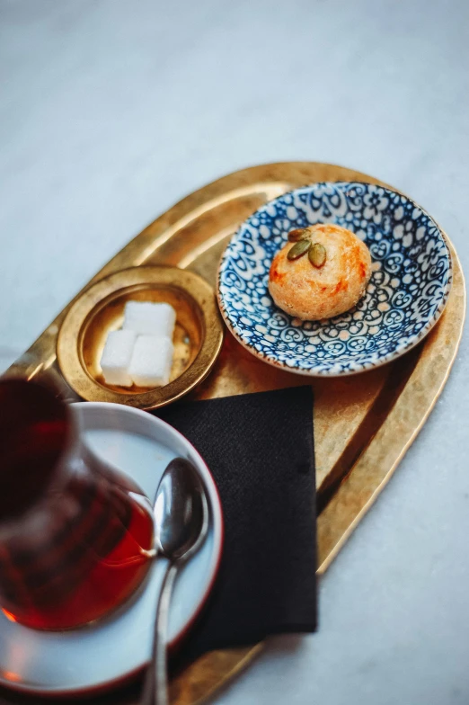 plate, bowl, cup and saucer with some fruit sitting on a wooden tray