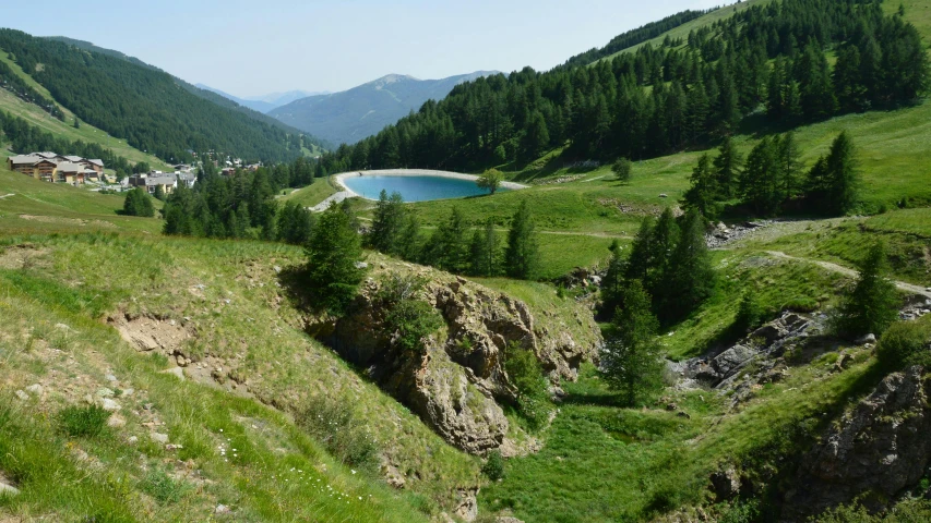 a large river sitting on the side of a green hillside