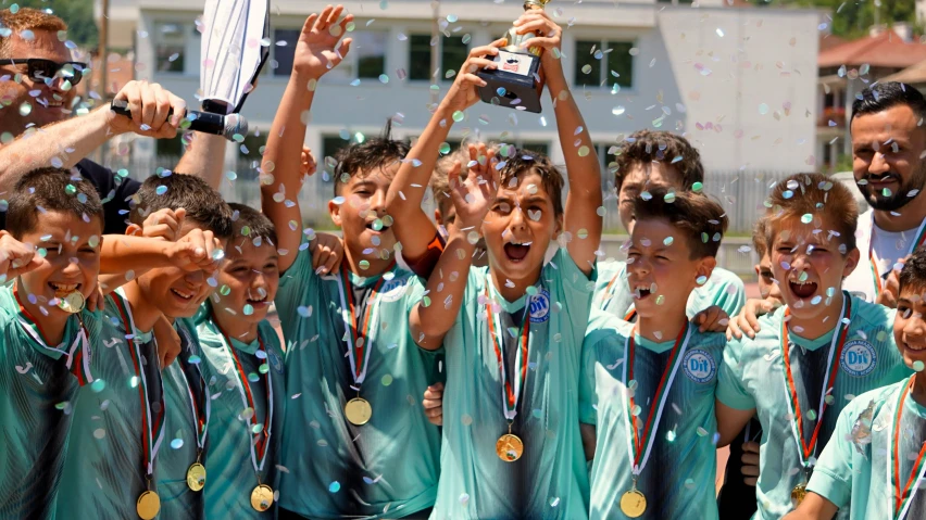 a group of boys and girls standing under bubbles