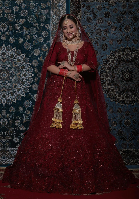 a woman in an elaborate, burgundy wedding dress