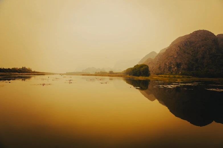 a lake and mountains in the distance with water around it