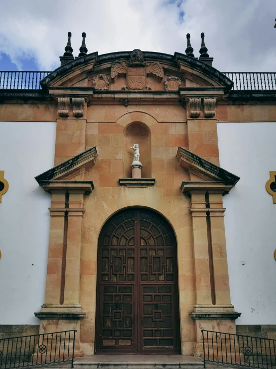 a church building with an ornate doorway with decorative columns