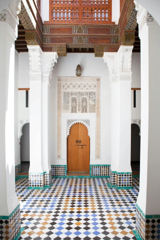 an arched doorway in an elaborate building with a tile floor