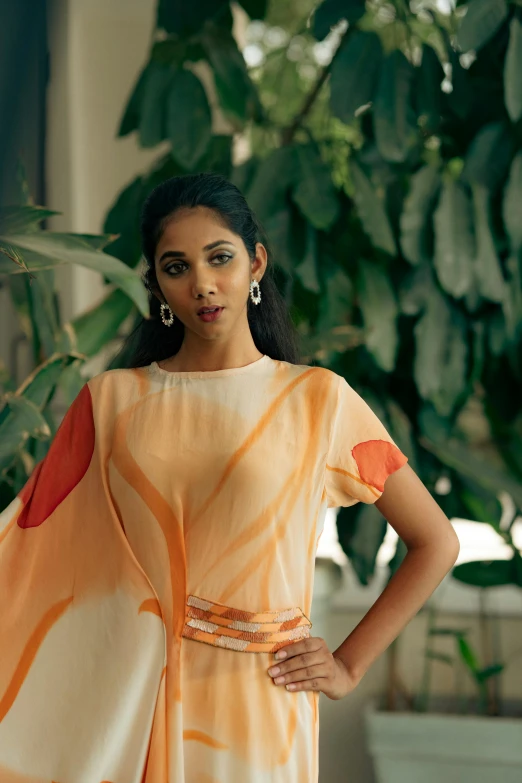 a beautiful indian woman in a flowing yellow cape