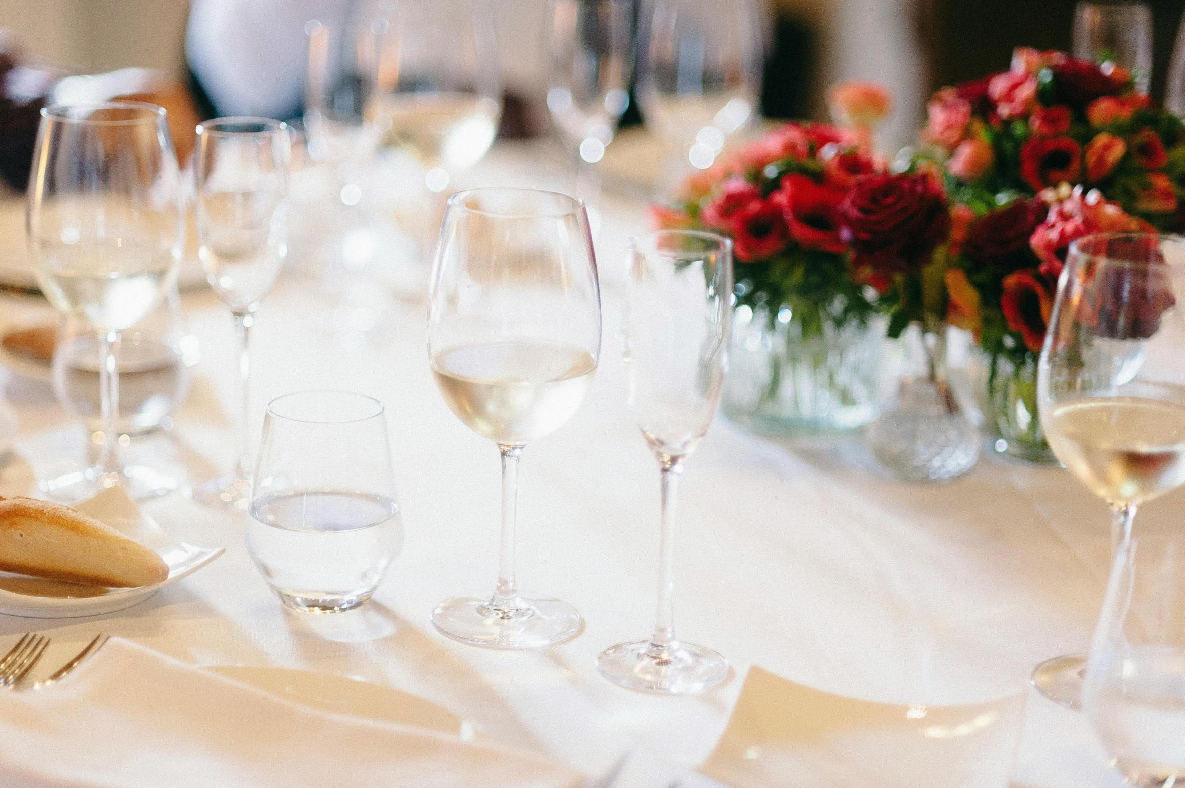 glasses filled with wine sit on the table