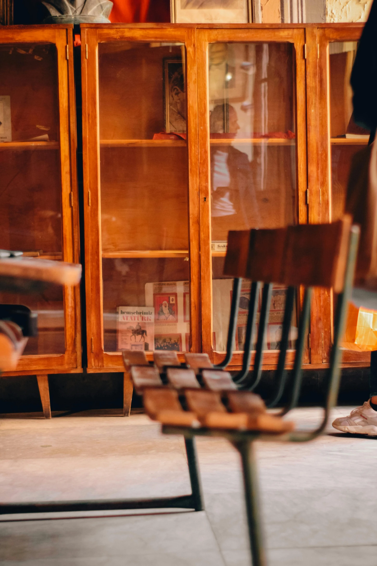 several wooden chairs sit side by side