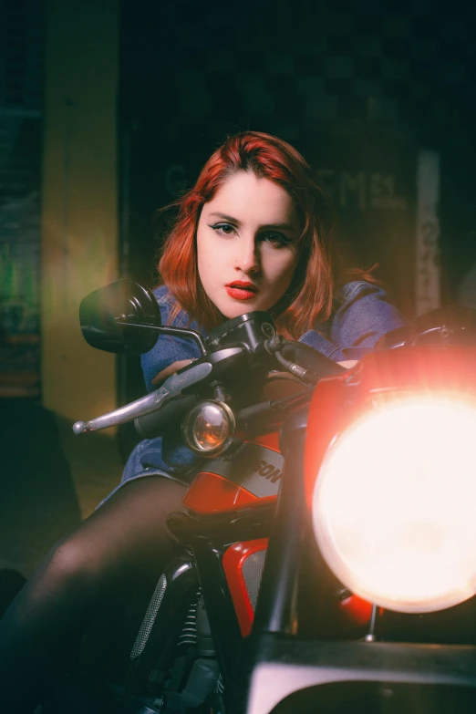 woman in blue jacket sitting on the back of a motorcycle