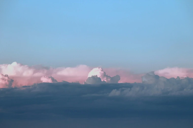 a cloud with a single airplane flying overhead