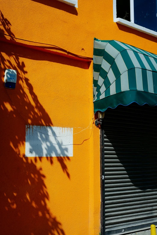 a very colorful orange building and a awning