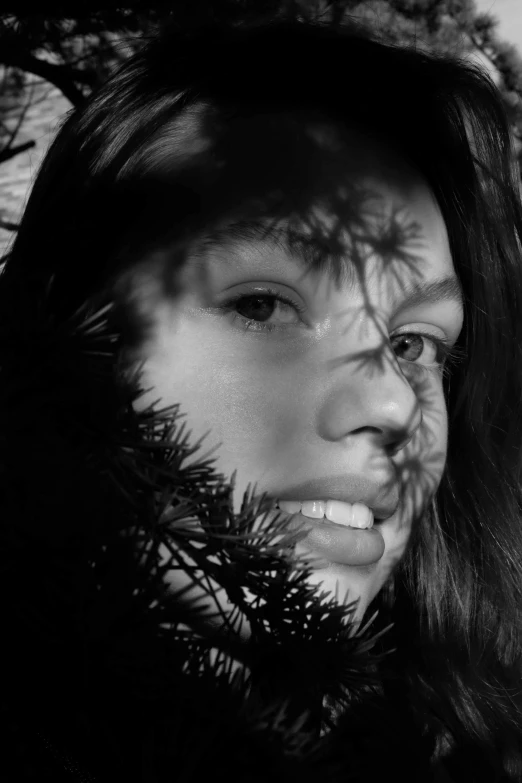 a woman standing outside and looking at the camera