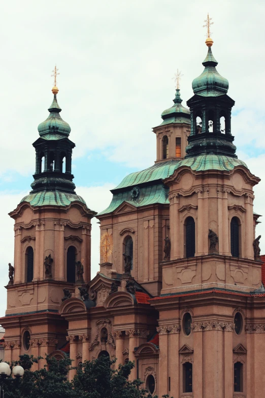 the three steeples on a building are blue and gold