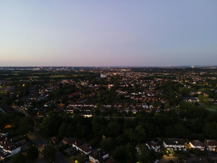 an aerial view of the city with trees and lights