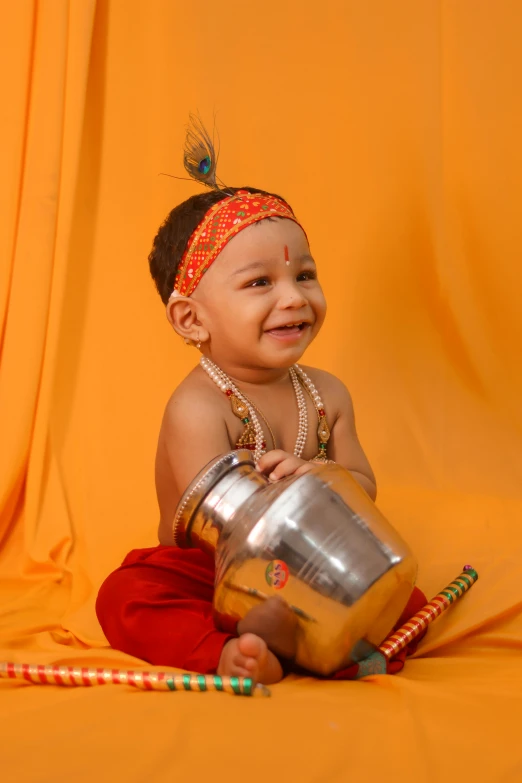 a baby with beads and a headband is smiling at the camera