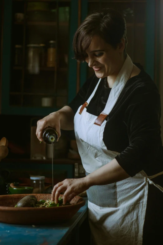 a woman is preparing food in a kitchen