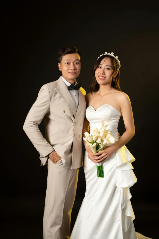 the young married couple poses for a po