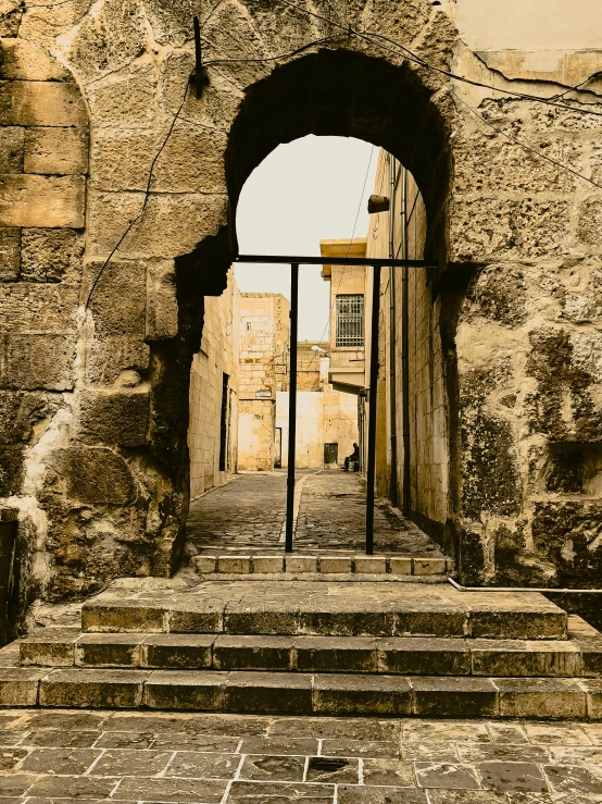 a large stone building with a gate and steps