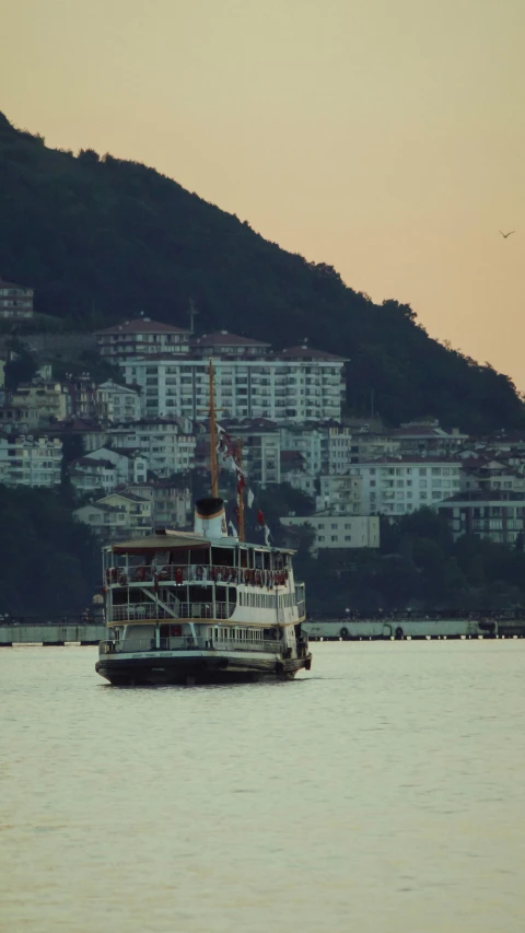 a boat in a harbor with some buildings in the background