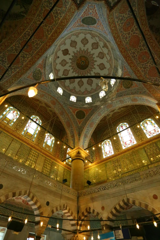 an ornate ceiling in the center of a building