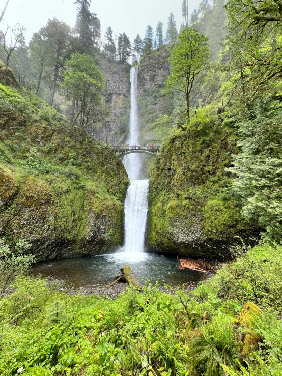 a waterfall flows into the river below it