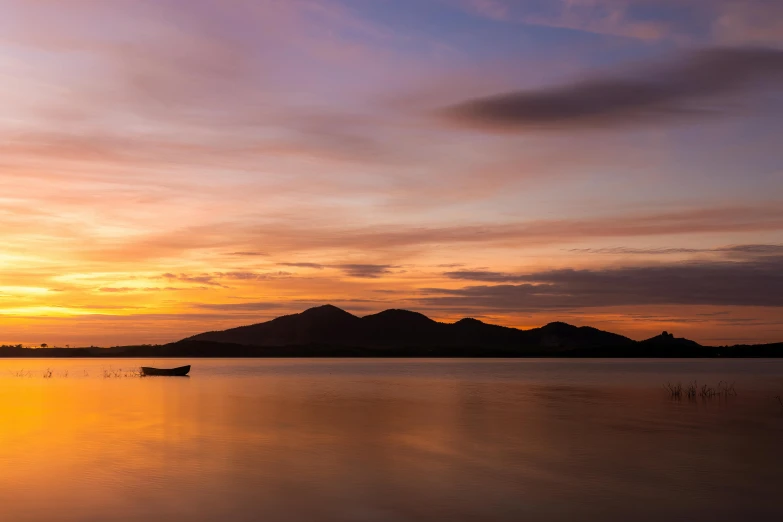 there is a boat on the water with a sky background