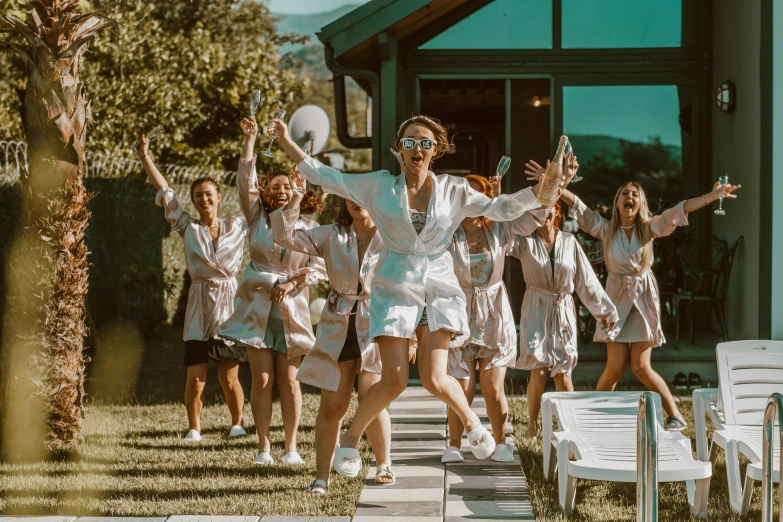 a bunch of women dressed in white dance