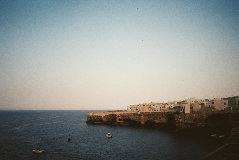 buildings line the shoreline of a large body of water