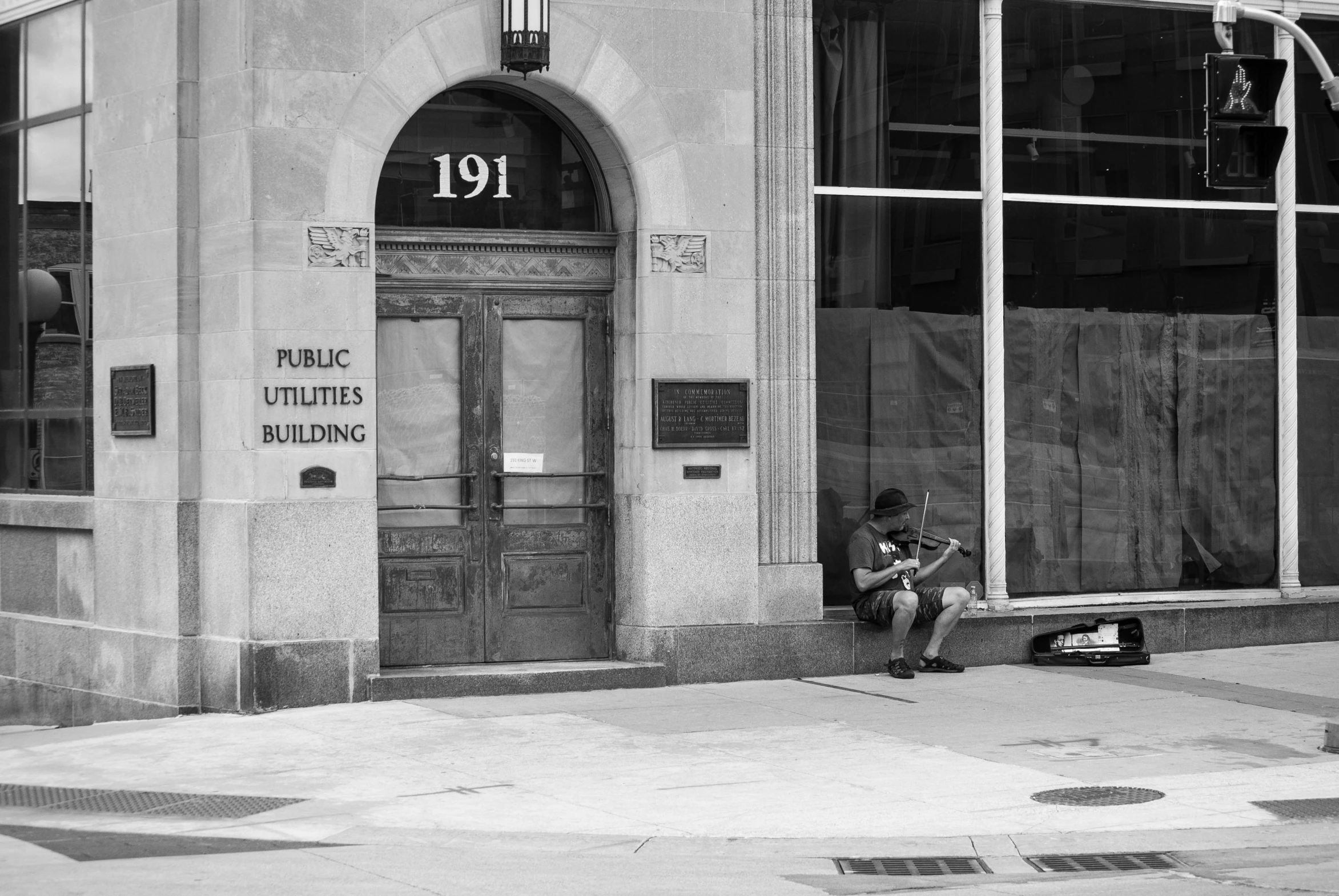 a man sitting in front of a building