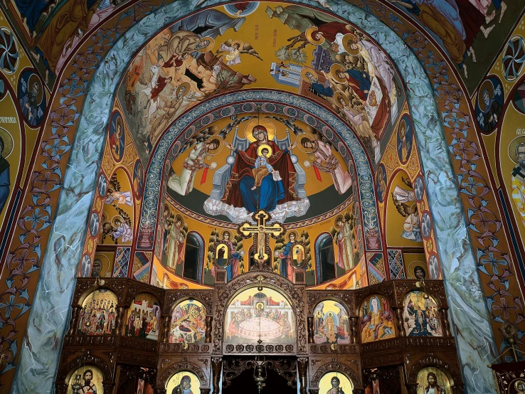 an ornate alter, showing icons and paintings on the wall