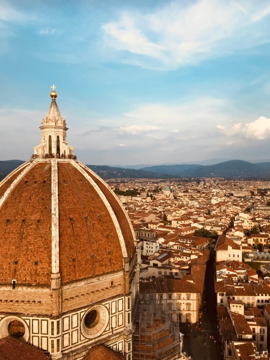 a tall brown dome in a city under a blue sky