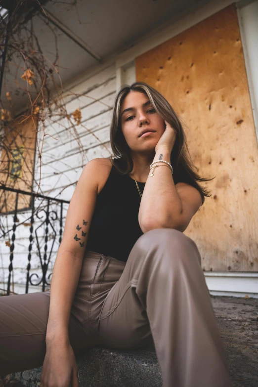 a woman in black shirt sitting on the ground