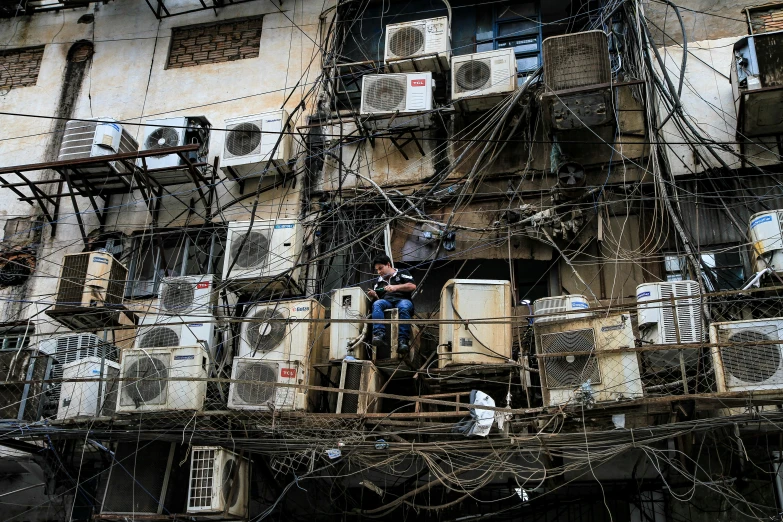 a dilapidated building with many wires attached to it