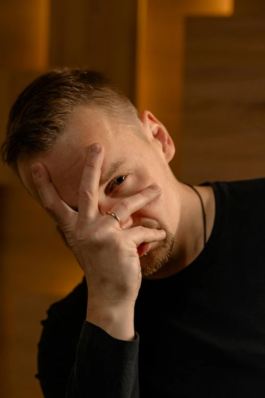 a man posing for a picture in a dark room