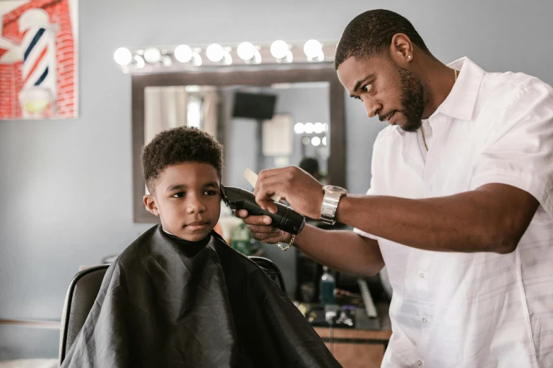 a barber  the hair of a child