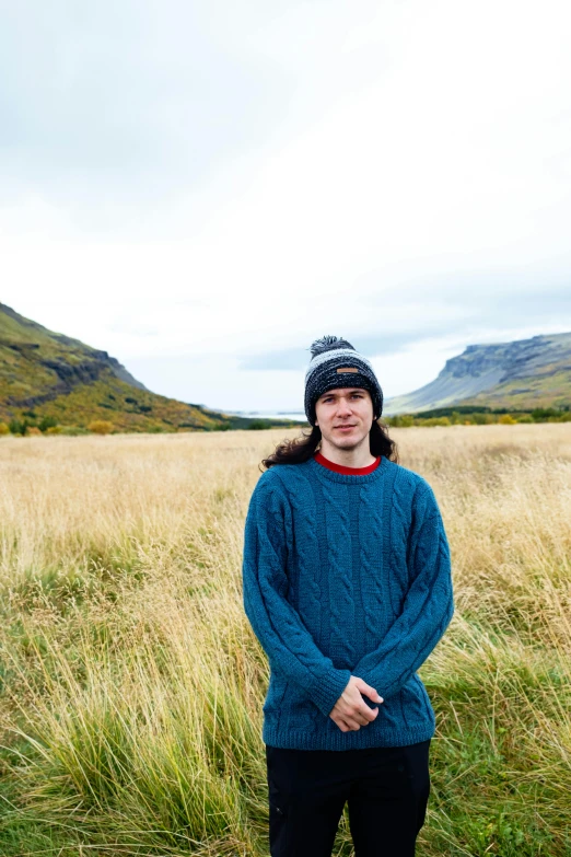 a man standing in the middle of an open field