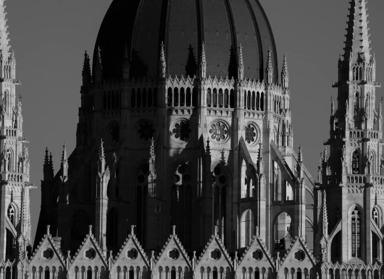 a large cathedral with a clock on the front and steeple