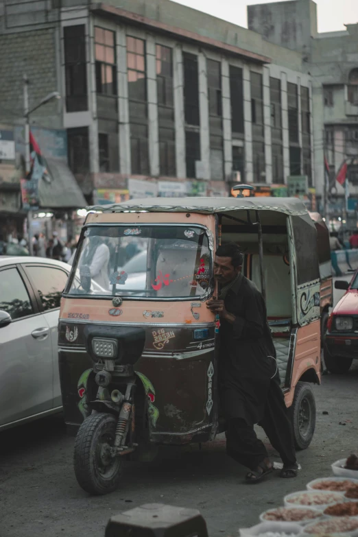 a man hing the wheel of a truck with a side car