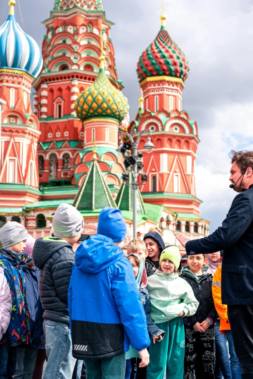 a man holding a small child in front of a group of people