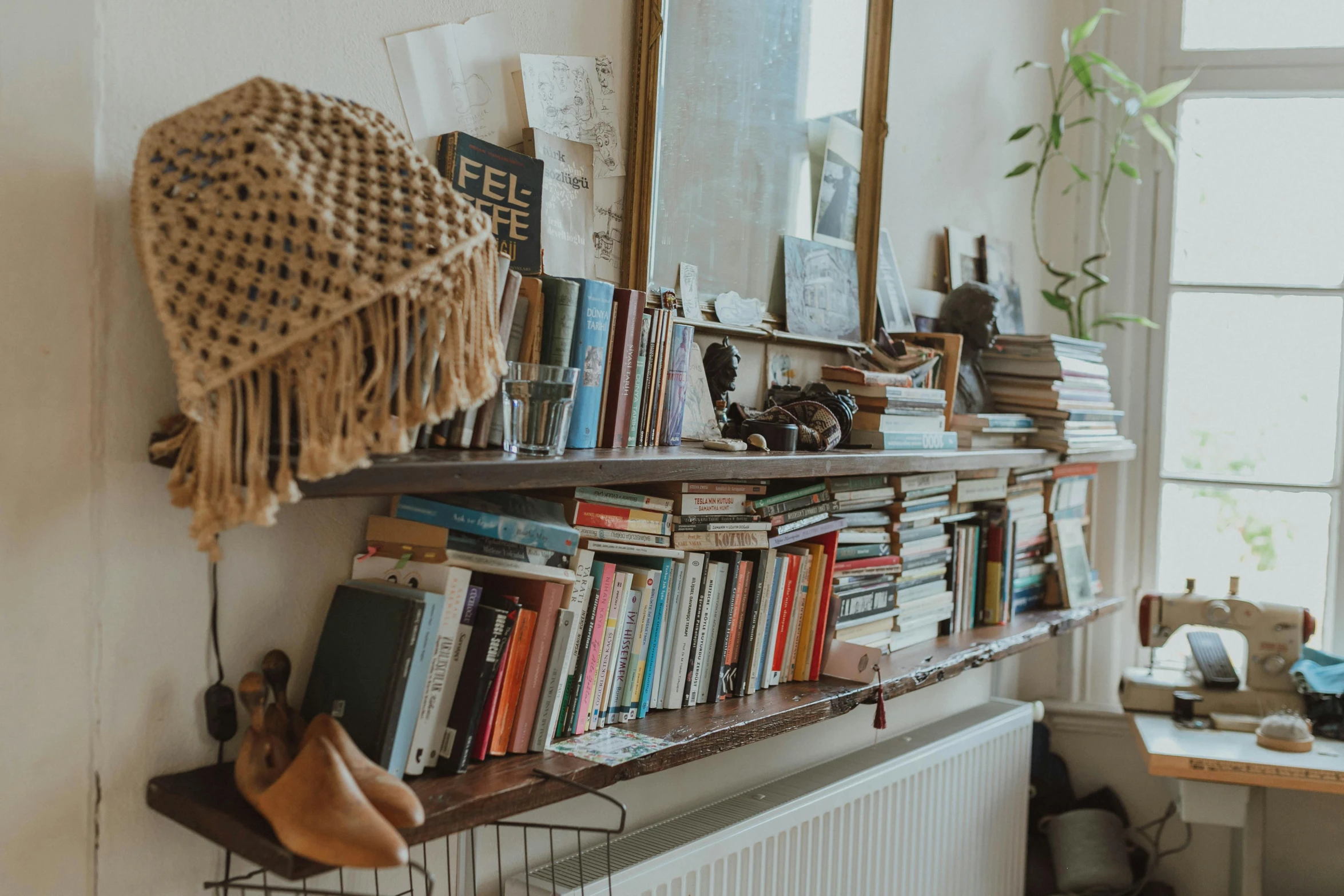 a bookshelf holds various books and baskets