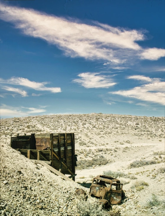 an old rusted truck parked in the desert