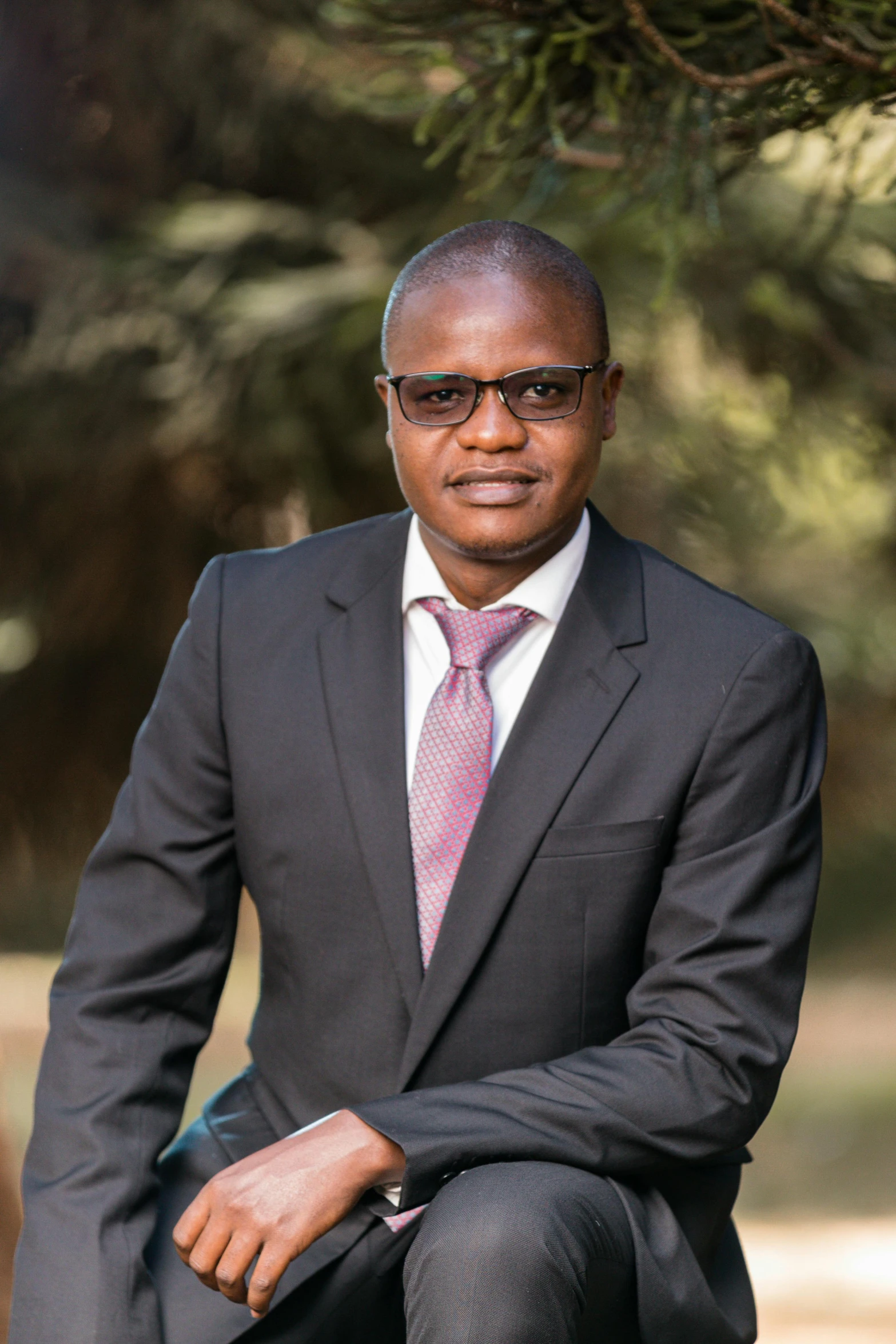 a man in glasses and a suit and tie