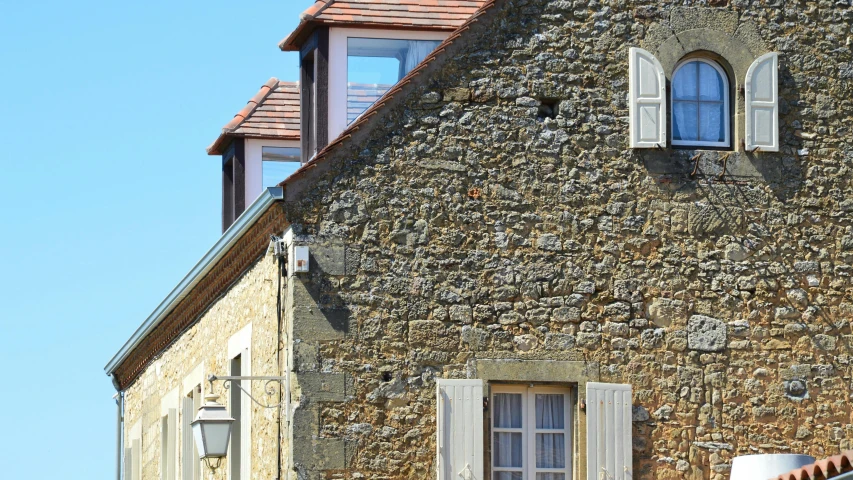 a large stone building with three windows in it