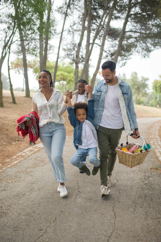 a group of people walking down a road holding bags