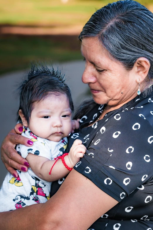 a woman holds a baby in her arms