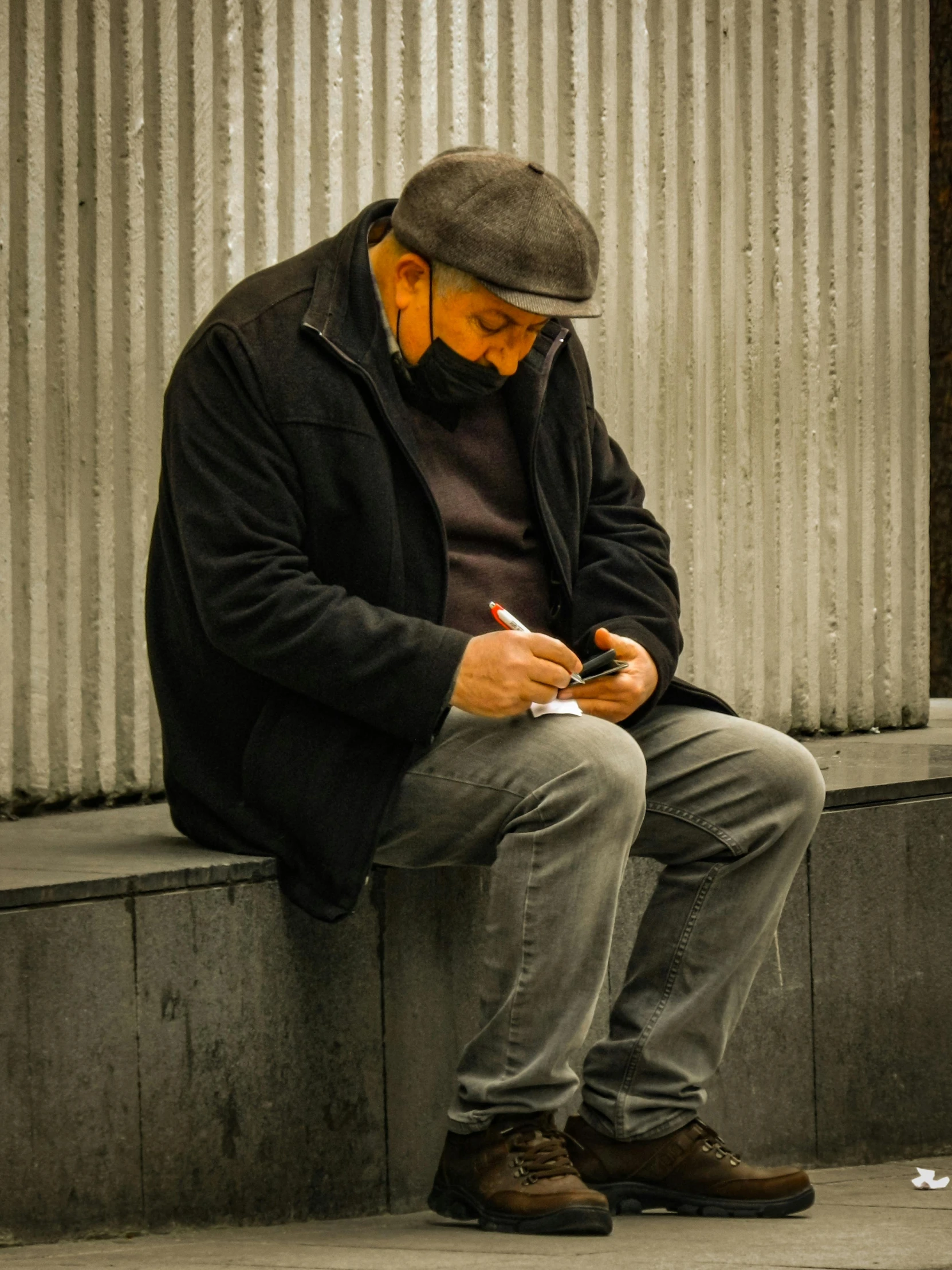 a man that is sitting down on a ledge