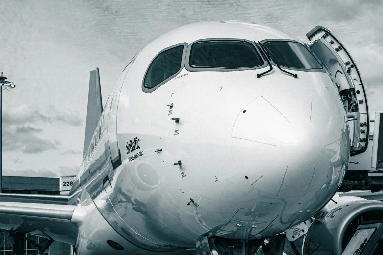 an airplane sitting on the runway waiting for passengers