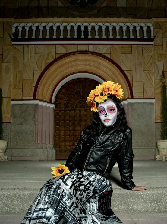 a skeleton makeup artist sitting on the ground